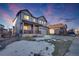 Two-story house with a red door and attached garage, snow on the lawn at 21186 E Layton Ave, Aurora, CO 80015