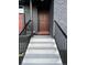 Modern front entrance with red door and black railings at 2220 S Vrain St, Denver, CO 80219