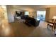 Open living area with hardwood floors, leather couches, and a balcony at 3144 S Wheeling Way # 410, Aurora, CO 80014
