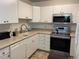 Bright kitchen with white cabinets and stainless steel appliances at 3144 S Wheeling Way # 410, Aurora, CO 80014