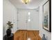 Bright entryway with hardwood floors, coat rack and art at 3228 S Xanadu St, Aurora, CO 80014
