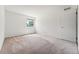 Large bedroom with neutral walls, carpet, and a window at 3228 S Xanadu St, Aurora, CO 80014