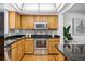 Kitchen with stainless steel appliances and wood cabinets at 3228 S Xanadu St, Aurora, CO 80014