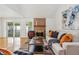 Spacious living room with hardwood floors, stone fireplace, and sliding glass doors at 3228 S Xanadu St, Aurora, CO 80014