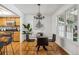 Dining area with glass table, chandelier, and access to patio at 3228 S Xanadu St, Aurora, CO 80014