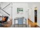 Home office with glass desk and chair near staircase and kitchen at 3228 S Xanadu St, Aurora, CO 80014