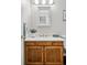 Bathroom vanity with wood cabinets and a marble countertop at 3228 S Xanadu St, Aurora, CO 80014