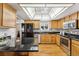 Bright kitchen featuring wood cabinets, granite countertops, and stainless steel appliances at 3228 S Xanadu St, Aurora, CO 80014