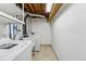 Basement laundry area with washer, dryer, shelving, and utility sink at 3228 S Xanadu St, Aurora, CO 80014