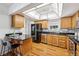 Modern kitchen with wood cabinets, granite countertops, and stainless steel appliances at 3228 S Xanadu St, Aurora, CO 80014