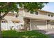 Front view of townhome with a garage and well-maintained lawn at 3228 S Xanadu St, Aurora, CO 80014