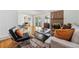 Open living area with hardwood floors and fireplace, view of dining area at 3228 S Xanadu St, Aurora, CO 80014
