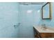 Basement bathroom with light blue tiled walls and a wood vanity at 3228 S Xanadu St, Aurora, CO 80014