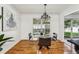 Dining area with glass table and chandelier, view of kitchen at 3228 S Xanadu St, Aurora, CO 80014
