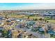 Aerial view showcasing the home's setting amongst other houses and green spaces at 5960 Rose Ln, Commerce City, CO 80022