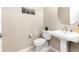 Stylish powder room with pedestal sink and a modern toilet at 10877 Skydance Dr, Highlands Ranch, CO 80126