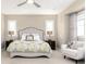 Main bedroom with plush bed and sitting area at 10877 Skydance Dr, Highlands Ranch, CO 80126