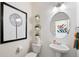 Small powder room with pedestal sink, toilet, and decorative wall art at 1871 Mount Monroe Dr, Berthoud, CO 80513