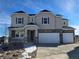 Two-story home with a front porch, stone accents, and a two-car garage at 5722 Farrier Pt, Castle Rock, CO 80104