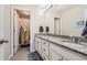 Bathroom boasts double vanity with granite countertop at 9884 Eagle River St, Littleton, CO 80125
