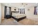 Main bedroom with ceiling fan and en-suite bathroom at 9884 Eagle River St, Littleton, CO 80125