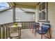 Cozy front porch with small table, chairs, and potted plants at 9884 Eagle River St, Littleton, CO 80125