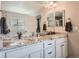 Double vanity bathroom with granite countertops and ample storage at 9884 Eagle River St, Littleton, CO 80125