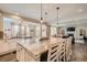 Spacious kitchen island with seating and open view to Gathering room at 9884 Eagle River St, Littleton, CO 80125