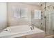 Main bathroom with soaking tub and walk-in shower at 9884 Eagle River St, Littleton, CO 80125