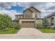 Two-story house with a two-car garage and landscaping at 9884 Eagle River St, Littleton, CO 80125