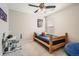 Cozy bedroom with wood bed frame and ceiling fan at 9884 Eagle River St, Littleton, CO 80125