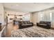 Open concept living room with kitchen views and hardwood floors at 9884 Eagle River St, Littleton, CO 80125