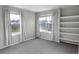 Bedroom with two windows, gray walls, and built in shelving at 9362 Autumn Ash Ct, Highlands Ranch, CO 80126