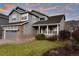Two-story house with gray siding, stone accents, and a landscaped lawn at 9362 Autumn Ash Ct, Highlands Ranch, CO 80126