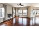 Bright living room with hardwood floors, fireplace, and large windows at 9362 Autumn Ash Ct, Highlands Ranch, CO 80126