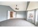 Large main bedroom with carpet, ceiling fan and access to other rooms at 9362 Autumn Ash Ct, Highlands Ranch, CO 80126