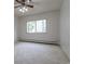 Well-lit bedroom with carpet, large window, and ceiling fan at 3144 S Wheeling Way # 209, Aurora, CO 80014