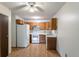 View of kitchen with wood cabinets and white appliances at 3144 S Wheeling Way # 209, Aurora, CO 80014