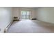 Living room with carpeted floor and sliding glass door to balcony at 3144 S Wheeling Way # 209, Aurora, CO 80014