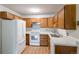 Kitchen boasts wood cabinets, white appliances, and light countertops at 3144 S Wheeling Way # 209, Aurora, CO 80014