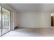 Bright living room with carpeted floor and balcony access at 3144 S Wheeling Way # 209, Aurora, CO 80014