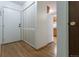 Apartment entryway with light wood floors, coat closet, and view into kitchen at 3144 S Wheeling Way # 209, Aurora, CO 80014