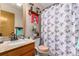 Bathroom with shower, single vanity, and decorative holiday towel at 12366 Jasmine Pl, Brighton, CO 80602