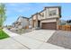 Two-story home with attached garage and landscaping at 9340 Bahama Ct, Commerce City, CO 80022