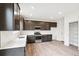 Modern kitchen with dark cabinetry, quartz countertops and stainless steel appliances at 9340 Bahama Ct, Commerce City, CO 80022