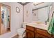 Clean bathroom with wood vanity, toilet, and mirror at 3612 S Waco Way, Aurora, CO 80013