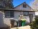 Rear view of house with a small patio and trash bins at 1964 Galena St, Aurora, CO 80010