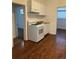 White appliances and wood-look floors in this galley kitchen at 1964 Galena St, Aurora, CO 80010