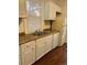 Kitchen features white cabinets, double sink, and dishwasher at 1964 Galena St, Aurora, CO 80010