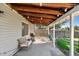 Covered patio with string lights, seating, and grill at 983 S Joplin Way, Aurora, CO 80017